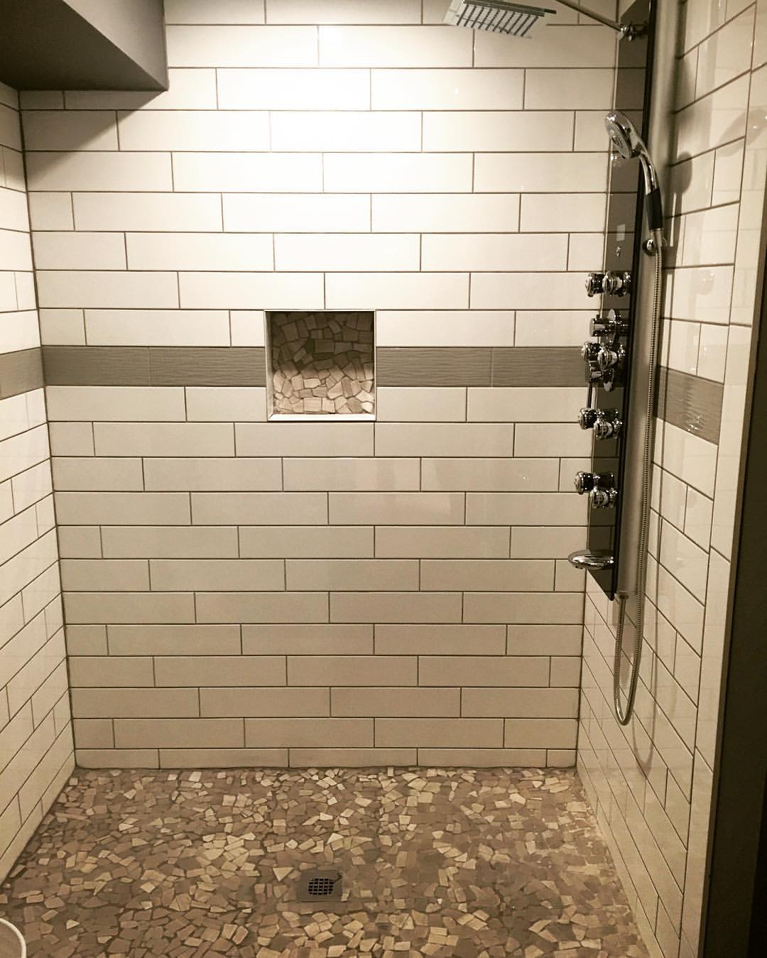 Luxury shower with subway tiles and mosaic details