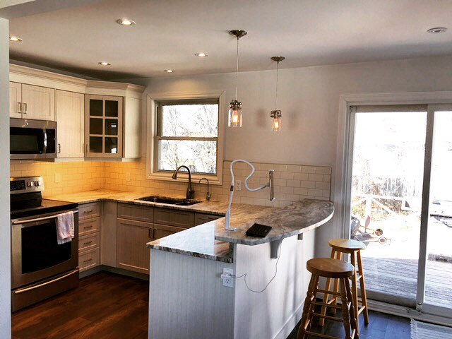 Bright modern kitchen with white cabinets and granite countertops