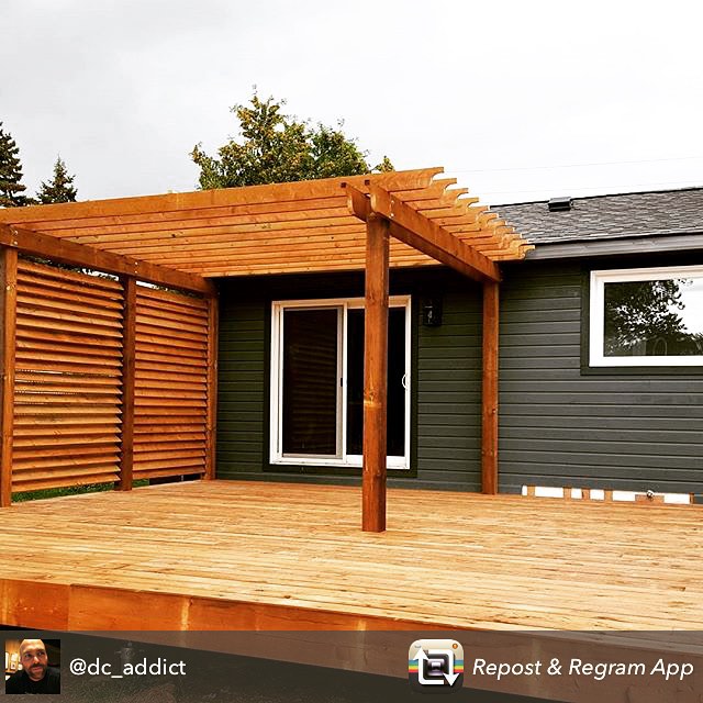 Contemporary wooden deck with pergola and privacy screening