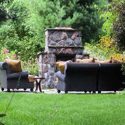 Outdoor stone fireplace with comfortable seating area